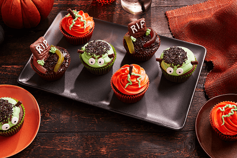 Halloween horror cupcakes served on a black rectangular plate