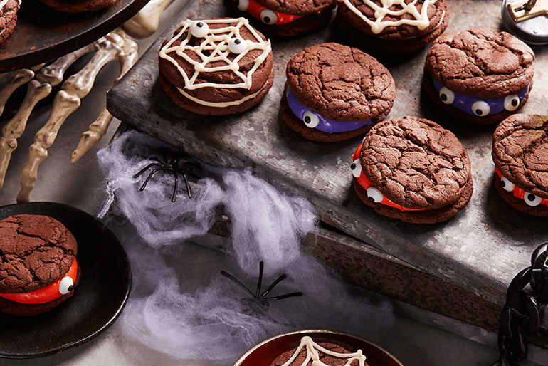 monster sandwich cookies served on table decorated with Halloween theme