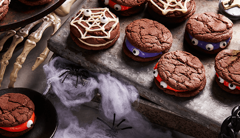 monster sandwich cookies served on table decorated with Halloween theme